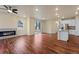 Open-concept living area with fireplace and kitchen featuring hardwood floors at 152 Ambrose St, Erie, CO 80516