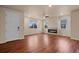 Bright living room features a modern fireplace, beautiful hardwood floors, and large windows at 152 Ambrose St, Erie, CO 80516