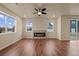 Bright living room featuring hardwood floors, lots of windows, and a fireplace at 152 Ambrose St, Erie, CO 80516