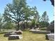 Community playground features a colorful play structure, mature trees, and green lawn at 152 Ambrose St, Erie, CO 80516
