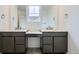 Modern bathroom featuring double vanities with gray cabinets and white countertops, providing ample space at 4588 Thistle Dr, Brighton, CO 80601