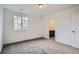 Bright bedroom featuring a closet, a window with a view, and neutral carpeting at 4588 Thistle Dr, Brighton, CO 80601