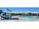 Community pool and water park area with slide and seating offering an amazing summertime experience at 4588 Thistle Dr, Brighton, CO 80601