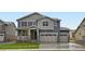 Charming two-story home with a three car garage and a beautifully landscaped front yard at 4588 Thistle Dr, Brighton, CO 80601