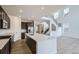 Modern kitchen features stainless steel appliances, dark cabinets, and a large white countertop island at 4588 Thistle Dr, Brighton, CO 80601
