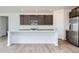 Modern kitchen features stainless steel appliances, white quartz countertops, and dark cabinets at 4588 Thistle Dr, Brighton, CO 80601
