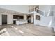 Open floor plan featuring the living room, kitchen, and a modern staircase with metal railings at 4588 Thistle Dr, Brighton, CO 80601