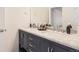 Stylish bathroom features double sinks with marble countertop and navy blue cabinets at 417 S Ouray St, Aurora, CO 80017