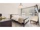 Bright bedroom with neutral decor, a chandelier, and large windows for natural light at 417 S Ouray St, Aurora, CO 80017