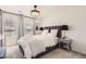 Inviting bedroom featuring a plush bed, stylish bedside lamps, and ample natural light at 417 S Ouray St, Aurora, CO 80017