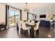 Stylish dining area with ample natural light and an open layout with dark hardwood floors at 417 S Ouray St, Aurora, CO 80017