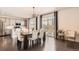 Open dining area with modern lighting, dark wood floors, and seamless access to outdoor patio at 417 S Ouray St, Aurora, CO 80017
