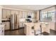 Modern kitchen featuring stainless steel appliances, a quartz countertop island, and stylish gray cabinets at 417 S Ouray St, Aurora, CO 80017