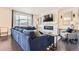 Elegant living room featuring a fireplace, large windows, dark wood floors, and stylish blue sofa at 417 S Ouray St, Aurora, CO 80017