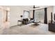 Relaxing living room with neutral carpet, grey sofa, and black ceiling fan at 417 S Ouray St, Aurora, CO 80017