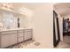 Bright bathroom features double sinks, gray vanity, and a large mirror with modern lighting at 417 S Ouray St, Aurora, CO 80017