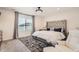 Relaxing bedroom with plush carpet, a tufted headboard, and soft natural light through window at 417 S Ouray St, Aurora, CO 80017