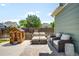 Cozy backyard patio with outdoor seating and a charming playhouse, perfect for relaxing and entertaining at 20389 E Powers Pl, Centennial, CO 80015