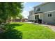 Well-maintained backyard featuring a lush lawn, patio seating, and playhouse, perfect for outdoor living and entertainment at 20389 E Powers Pl, Centennial, CO 80015