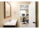 Bathroom vanity features a large mirror, open door to workout room at 20389 E Powers Pl, Centennial, CO 80015