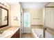 This bathroom is equipped with a soaking tub and a single sink vanity with a view to the exterior at 20389 E Powers Pl, Centennial, CO 80015