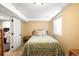 Cozy bedroom has natural light from the window and a bed with a patterned comforter at 20389 E Powers Pl, Centennial, CO 80015