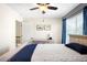 The bedroom features a ceiling fan, large window, neutral paint and decor at 20389 E Powers Pl, Centennial, CO 80015