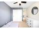 Bedroom with natural light features a closet, dresser, and carpeted floor at 20389 E Powers Pl, Centennial, CO 80015