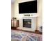 Living room fireplace with marble surround and adjacent storage at 20389 E Powers Pl, Centennial, CO 80015