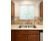 The kitchen sink features stainless steel with a neutral colored counter top and diamond patterned backsplash at 20389 E Powers Pl, Centennial, CO 80015