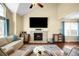 Living room with fireplace, hardwood flooring, ceiling fan, and plenty of natural light at 20389 E Powers Pl, Centennial, CO 80015