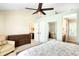 Brightly lit main bedroom features a ceiling fan, sitting area and a view of the en suite bathroom at 20389 E Powers Pl, Centennial, CO 80015
