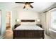 This main bedroom has a ceiling fan, a view of an en suite bathroom and lots of light at 20389 E Powers Pl, Centennial, CO 80015