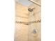 The full bathroom features a shower with a chrome shower head and tiled surround at 20389 E Powers Pl, Centennial, CO 80015