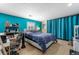 Basement bedroom with teal walls, a queen bed, and a small workspace at 1395 Bellaire St, Denver, CO 80220