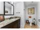 Clean bathroom with granite vanity and updated toilet at 1395 Bellaire St, Denver, CO 80220