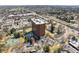 Aerial view of the building with surrounding landscape and Denver skyline at 1900 E Girard Pl # 907, Englewood, CO 80113
