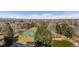 Aerial view featuring the property's lush landscaping, tennis court, pond, and surrounding neighborhood at 1900 E Girard Pl # 907, Englewood, CO 80113