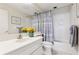 Bathroom with a vanity, mirror, and shower featuring light-colored fixtures and a clean design at 1900 E Girard Pl # 907, Englewood, CO 80113