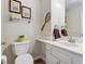 Charming half-bathroom featuring tennis racket decor, white vanity, and classic fixtures at 1900 E Girard Pl # 907, Englewood, CO 80113