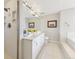 Bright, clean bathroom featuring a double vanity, walk-in shower, white tile floor, and lovely decor at 1900 E Girard Pl # 907, Englewood, CO 80113