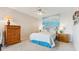 Cozy bedroom features a queen bed, ocean-themed decor, and lots of storage in matching wood furniture at 1900 E Girard Pl # 907, Englewood, CO 80113