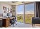 Bedroom featuring a work space and large windows offering stunning views of the surrounding landscape at 1900 E Girard Pl # 907, Englewood, CO 80113