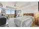 Bright bedroom featuring a work space, ceiling fan, carpet flooring, and large windows with scenic views at 1900 E Girard Pl # 907, Englewood, CO 80113
