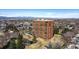 Aerial view of a high-rise building surrounded by lush landscaping, trees, and residential neighborhoods at 1900 E Girard Pl # 907, Englewood, CO 80113