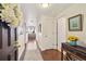 Inviting entryway hallway with hardwood floors, elegant decor, and a glimpse of the living room beyond at 1900 E Girard Pl # 907, Englewood, CO 80113