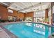 Inviting indoor pool surrounded by plants and lounging chairs creating a relaxing atmosphere at 1900 E Girard Pl # 907, Englewood, CO 80113