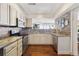 Charming kitchen with brick backsplash, stainless steel appliances, and ample counter space at 1900 E Girard Pl # 907, Englewood, CO 80113
