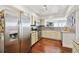 Well-equipped kitchen featuring stainless steel appliances, brick backsplash, and updated countertops at 1900 E Girard Pl # 907, Englewood, CO 80113