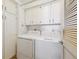 Functional laundry room with washer, dryer, and built-in cabinets for organized storage and convenience at 1900 E Girard Pl # 907, Englewood, CO 80113